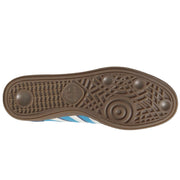 The outsole of a brown Adidas sneaker, showing the textured tread pattern and embossed Adidas logo, with a hint of light blue and white stripes visible on the side.