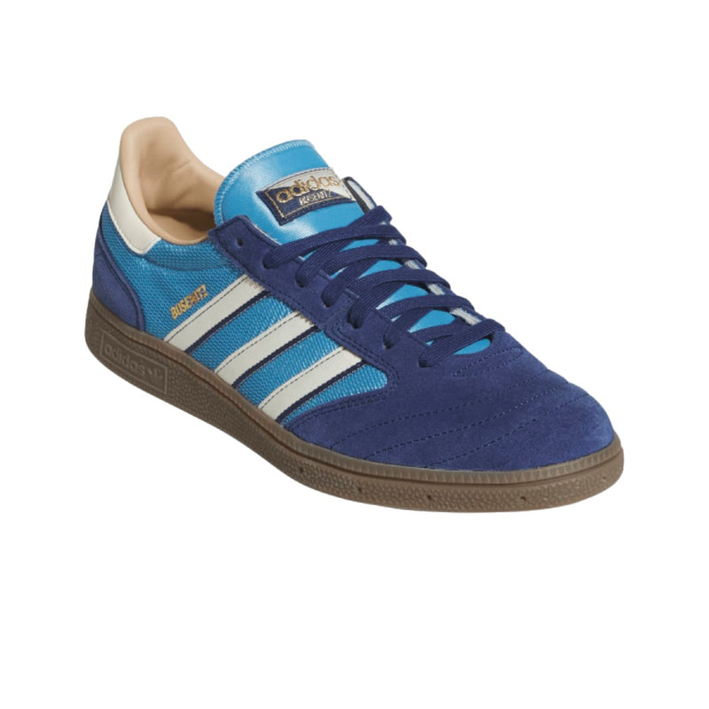 An Adidas Busenitz sneaker in royal blue suede and mesh, featuring three white stripes, a brown gum sole, and gold branding details.