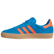 A low-top sneaker in bright blue suede with three orange stripes, an orange heel tab, and a tan gum sole.    