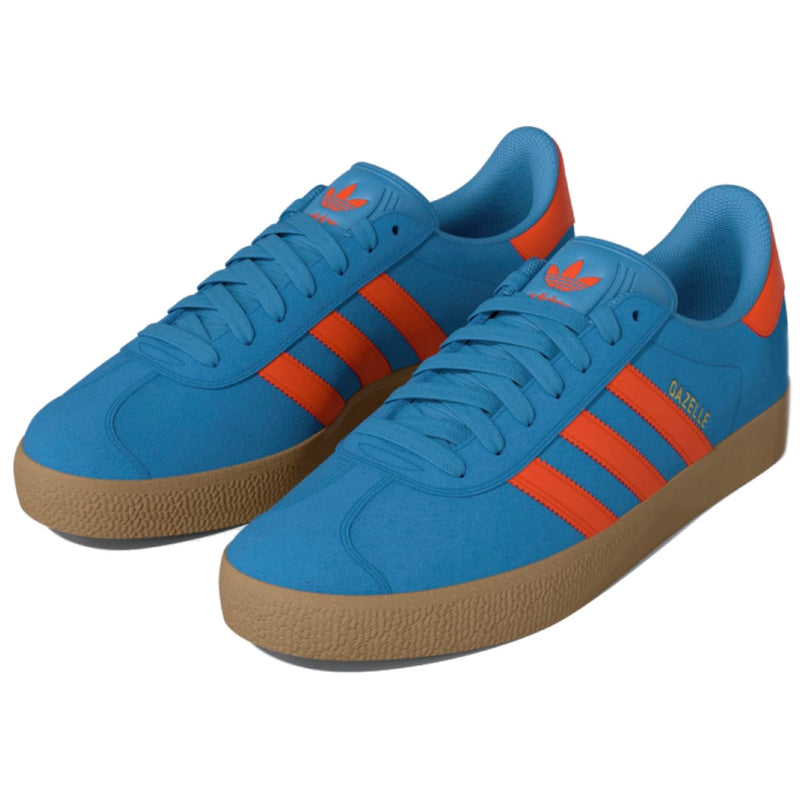 A pair of Adidas Gazelle sneakers in blue suede with bright orange stripes and a gum sole.