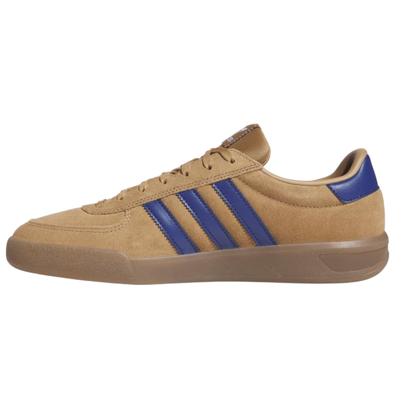 A low-top suede sneaker in tan with three royal blue stripes on the side, a blue heel tab, and a gum sole.