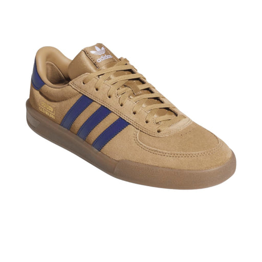 An Adidas Samba sneaker in tan suede with blue three-stripes and a brown gum sole.