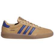 An Adidas Samba sneaker in tan suede with royal blue stripes and heel tab.