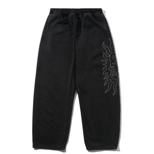 Butter Goods Solar Track Pants - Black Black sweatpants with an elastic drawstring waist and a white line-art graphic on the right leg.