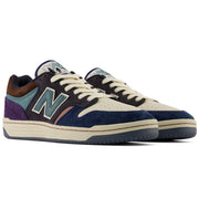 New Balance Numeric 480 x 35th North sneakers in a colorway featuring navy blue suede, cream leather, purple suede, teal suede, and brown suede, with white laces and a cream midsole.