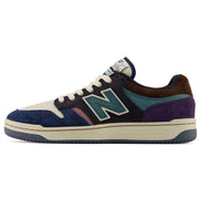 New Balance Numeric 480 x 35th North  sneaker in navy blue suede and mesh with purple suede overlays, a teal embroidered 'N' logo, cream laces and midsole, and a brown suede heel tab, shown in a side profile on a white background.