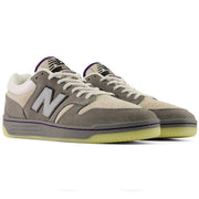 New Balance Numeric 480 x Civil sneakers in a muted taupe-gray and cream colorway with purple accents on the tongue, laces, and midsole, set against a plain white background.