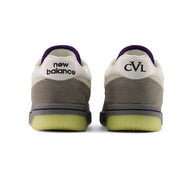 New Balance Numeric 480 x Civil sneakers shown from the back, featuring a white and gray suede upper with a textured gray midsole, a purple collar lining, and a translucent yellow-green outsole.