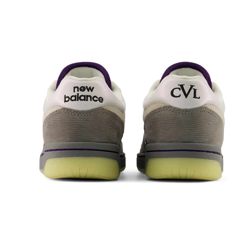 New Balance Numeric 480 x Civil sneakers shown from the back, featuring a white and gray suede upper with a textured gray midsole, a purple collar lining, and a translucent yellow-green outsole.