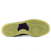 The outsole of a New Balance Numeric 480 x Civil Skateshop sneaker, showing a translucent light yellow-green rubber tread with a dark purple heel insert featuring the embossed New Balance 'N' logo.