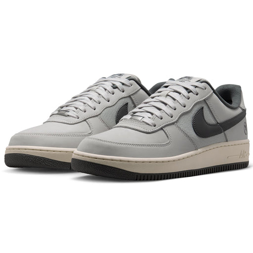  Nike SB Air Force 1 x Yuto sneakers in light gray and black, featuring a light gray leather and mesh upper, black Swoosh, and a beige midsole with a black outsole.