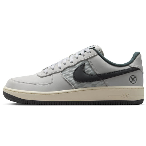  Nike SB Air Force 1 x Yuto sneaker in light gray and dark gray, featuring a cream-colored midsole and a black outsole, shown from a side profile view on a white background.