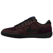 A Nike low-top sneaker in dark burgundy and black suede, featuring a black Swoosh and a small blue accent on the tongue.