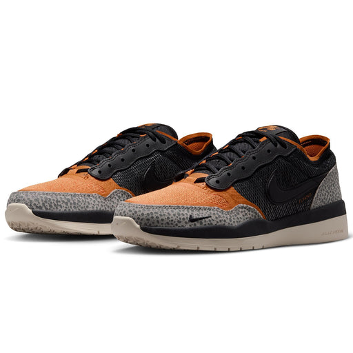 Nike SB PS8 - Friends & Family sneakers in black and orange, featuring a speckled gray and black canvas toe, black mesh side panels with a black Swoosh, and a beige rubber outsole.