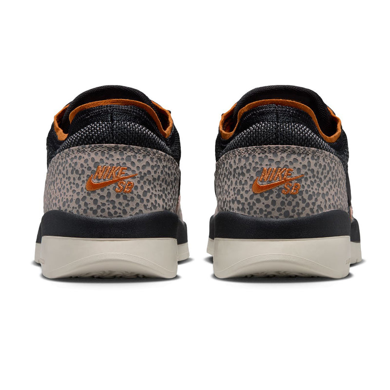 Nike SB PS8 - Friends & Family shown from the back, featuring a textured black and gray leopard print heel counter with an orange Nike SB logo, a black knit upper, and orange lining, set against a plain white background.