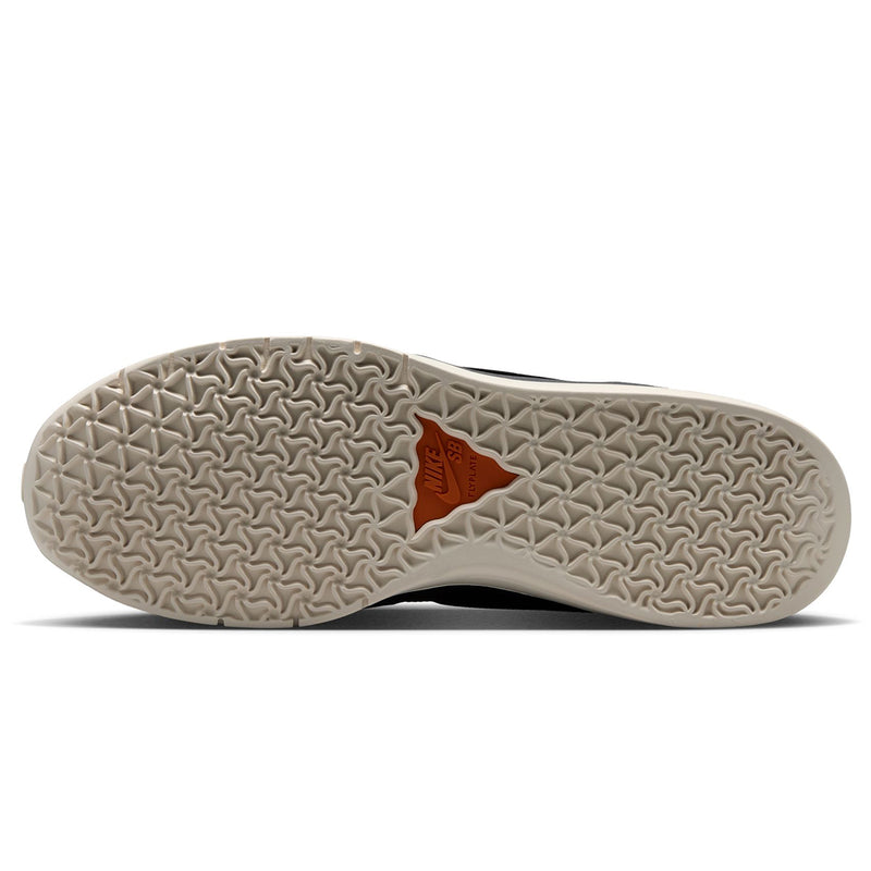 Nike SB PS8 - Friends & Family outsole of a sneaker shown from a top-down view, featuring a textured beige tread pattern with a small orange triangular logo in the center.