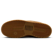 A close-up, top-down view of a brown rubber shoe sole, showing the tread pattern and textured grip.
