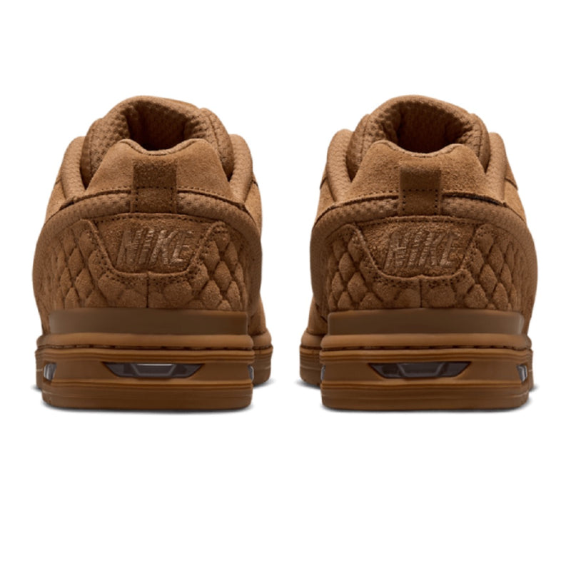 A pair of Nike low-top sneakers shown from the back, featuring a brown quilted suede and mesh upper with a matching brown sole.