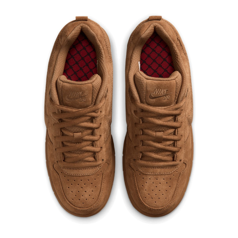 A pair of Nike SB Paul Rodriguez sneakers in a monochromatic tan suede and leather finish, featuring a red checkered pattern visible on the inner lining.