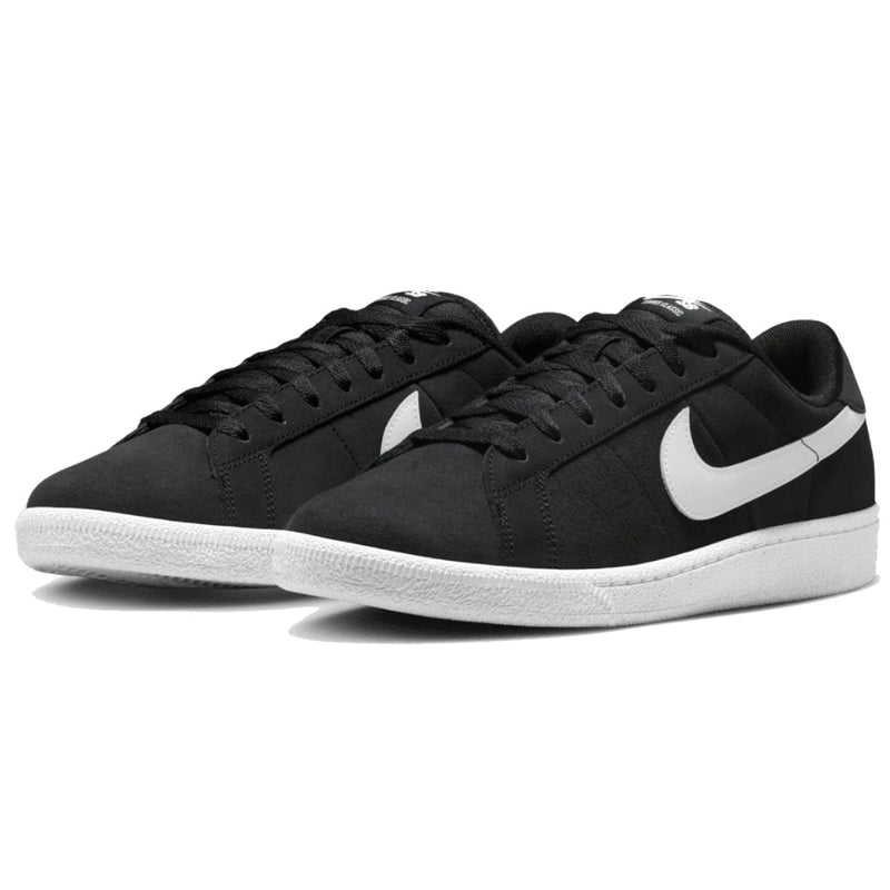 A pair of Nike low-top sneakers in black suede with a contrasting white Swoosh and white rubber sole.