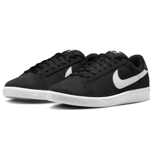 A pair of Nike low-top sneakers in black suede with a contrasting white Swoosh and white rubber sole.