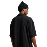 Nike SB Solid Break AF1 Polo in Black / Court Green, back view on model